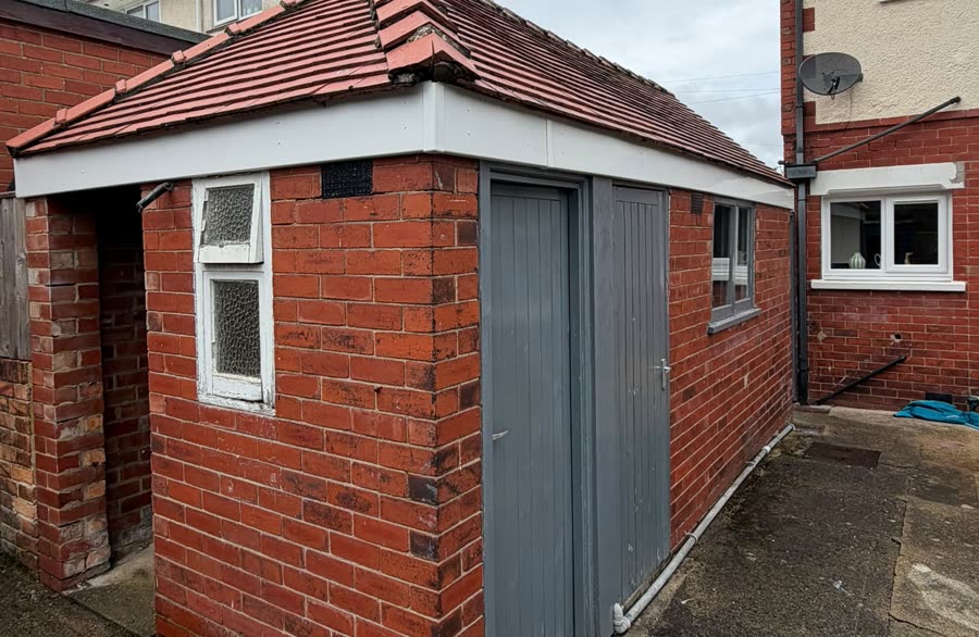 The same garage after new white fascia boards were fitted